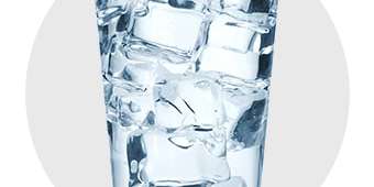 Glass of water with ice cubes for beverages.