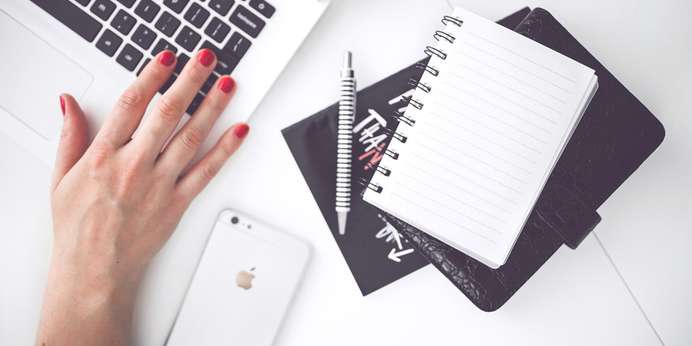 woman-hand-smartphone-desk-large.jpg